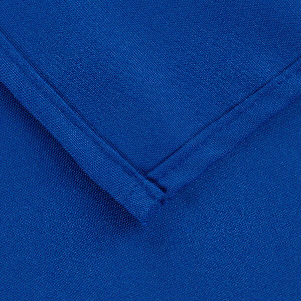 A close up of a royal blue rectangular cloth table cover with a folded edge.