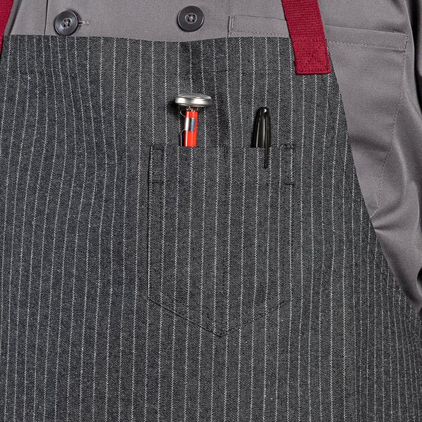 a person wearing a apron with a pen and a tool in it