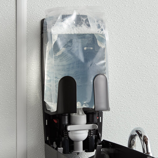 A Rubbermaid Flex enriched foam hand and body shampoo refill bag in a soap dispenser.