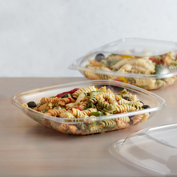 A clear Fineline plastic bowl filled with pasta and vegetables.