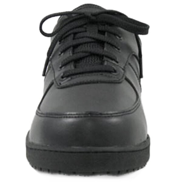 A close-up of a black Genuine Grip women's leather shoe with laces.