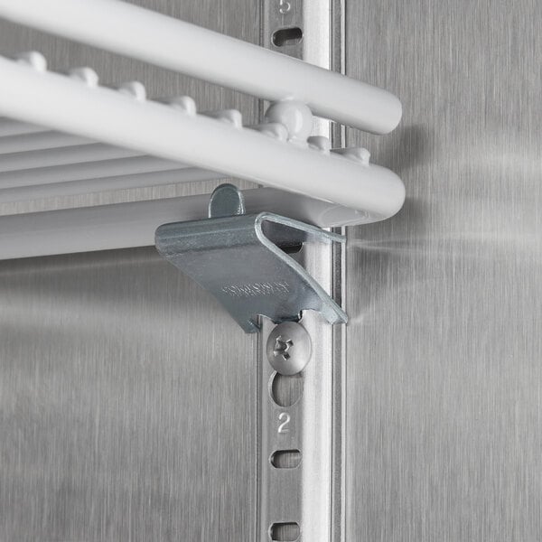 A white Beverage-Air glass door freezer shelf with metal rod hooks.