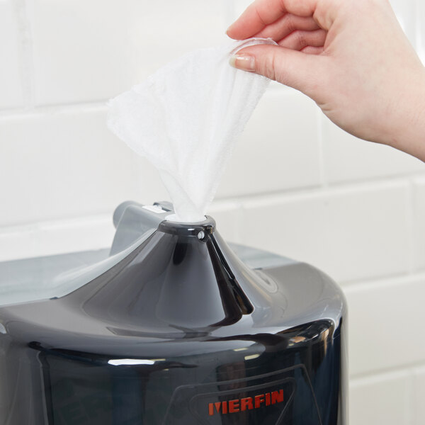A hand pulling a Merfin Mates pre-moistened personal care wipe from a black plastic box.