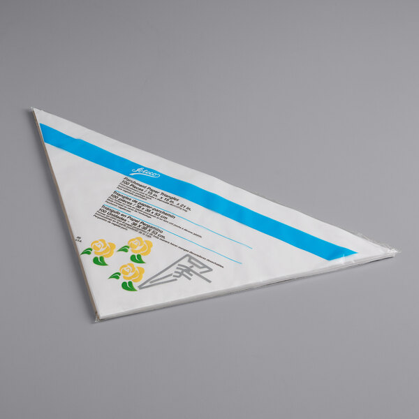 A package of triangular white parchment pastry bags with blue and yellow flowers on it.