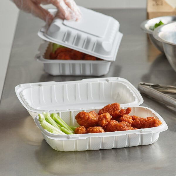 A hand using a Dart white mineral-filled hinged lid to cover a container of food.