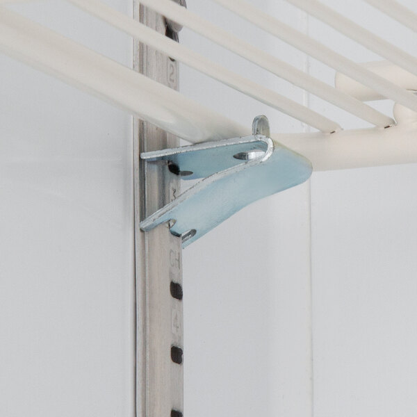 A metal bracket on a white shelf inside a Beverage-Air black glass door freezer.