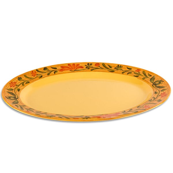 A yellow oval GET Venetian melamine platter with a floral design.
