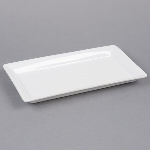 A white rectangular American Metalcraft stoneware platter on a gray surface.