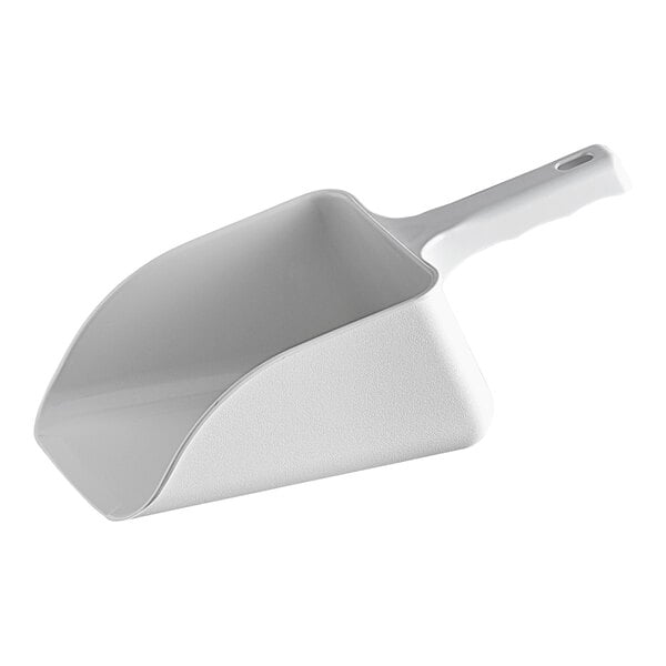 A white plastic scoop with a handle in an ice bin.
