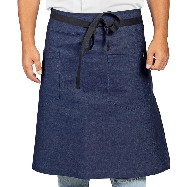 A man wearing a Uncommon Chef indigo denim bistro apron with black webbing.