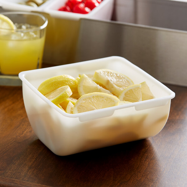 A white Thunder Group condiment dispenser insert with lemon slices in it.