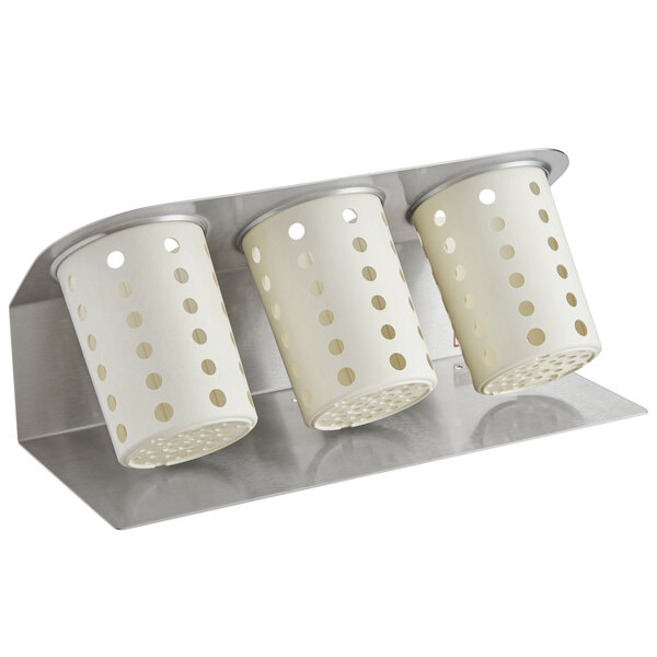 A Steril-Sil silver flatware organizer with three white perforated cylinders on it.