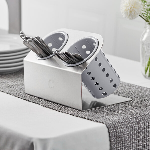 a silver container with silverware in it