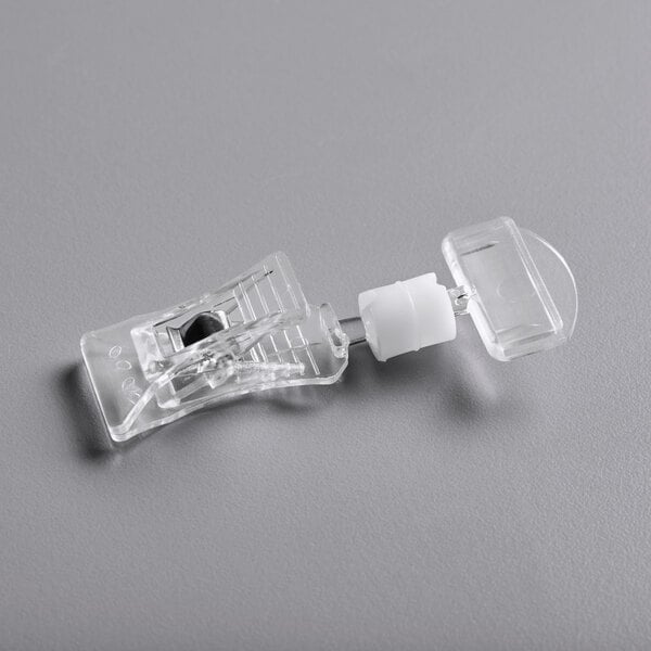 A clear plastic device with a small piece of plastic at the end.