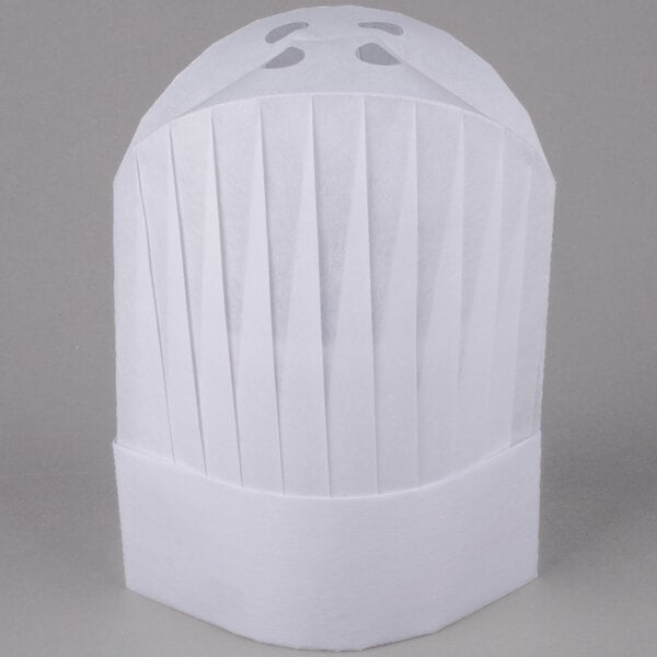 A close up of a white Royal Paper disposable chef hat with pleats.