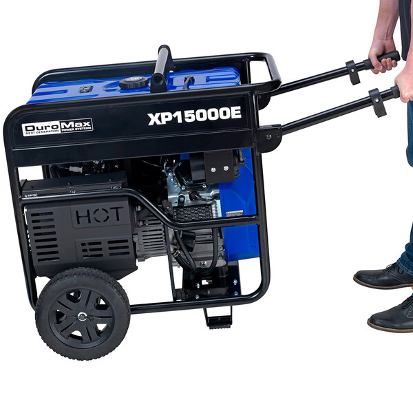 A person using the electric start on a DuroMax portable generator.