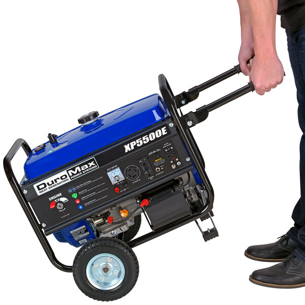 A person using the DuroMax XP5500E portable generator.