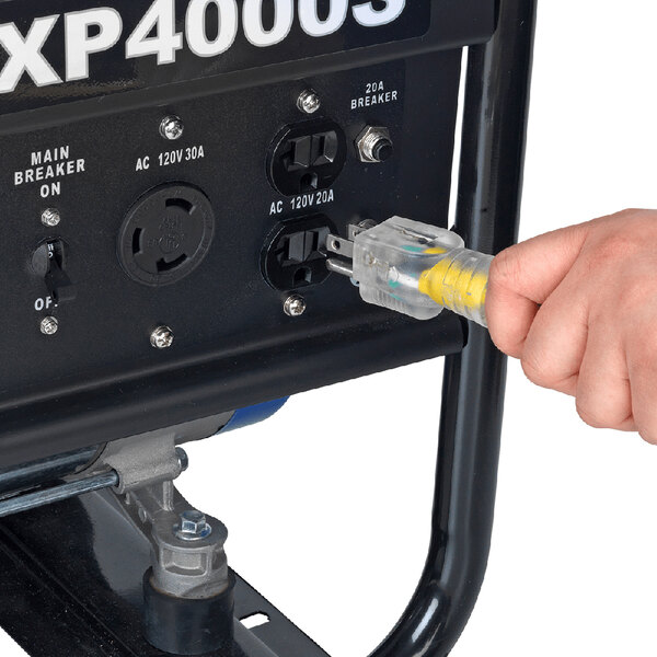 A person plugging a yellow cord into a DuroMax portable generator.