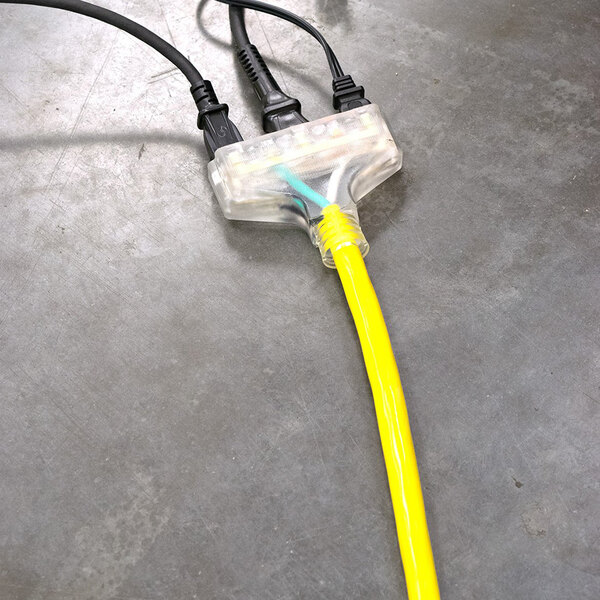 A yellow DuroMax extension cord with black and yellow triple tap connectors.