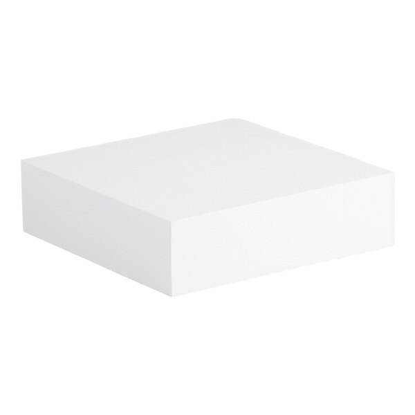 A square white foam cake dummy measuring 14 inches by 14 inches by 4 inches.