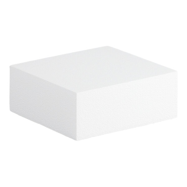 A square foam cake dummy measuring 10 inches by 10 inches by 4 inches.