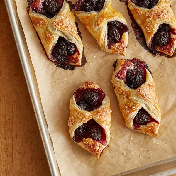 A tray of croissants with Boysenberries inside.