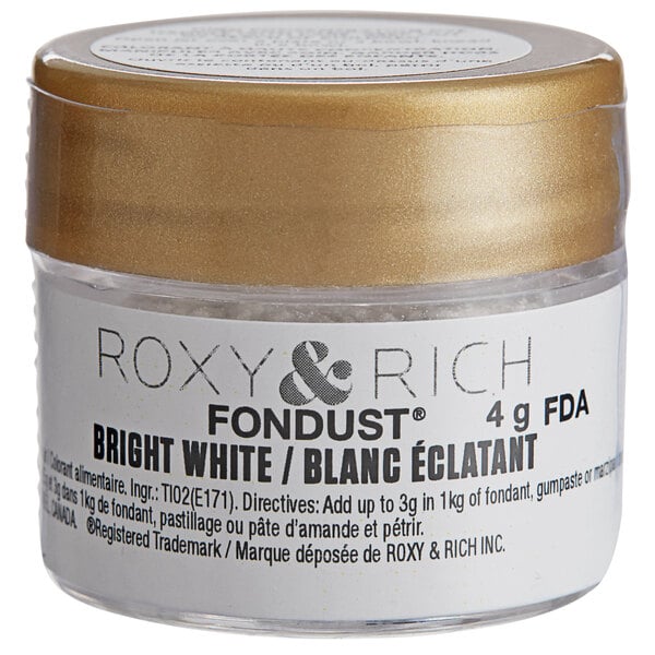 A small container of Roxy & Rich Bright White Fondust with a gold lid and label.
