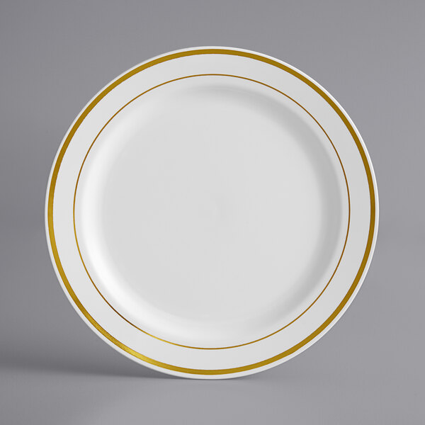 A white plastic plate with gold bands.