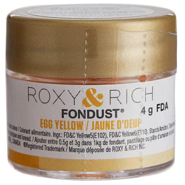 A small container of Roxy & Rich Egg Yellow Fondust powder with a label.