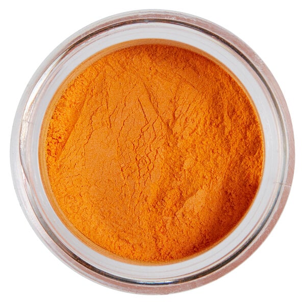 A jar of orange powder with a white label.