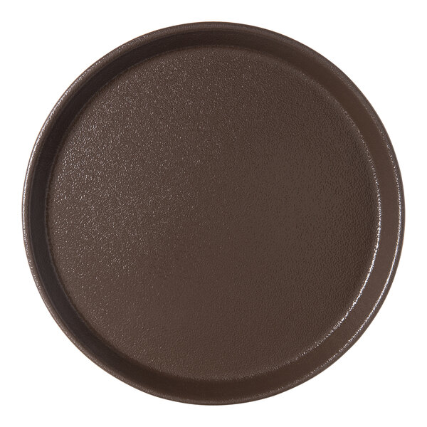 A brown round Carlisle Griptite 2 non skid fiberglass serving tray.