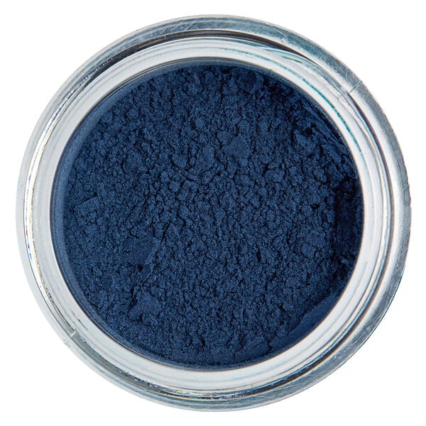 A jar of Roxy & Rich Teal Fondust powder with a blue powder inside.