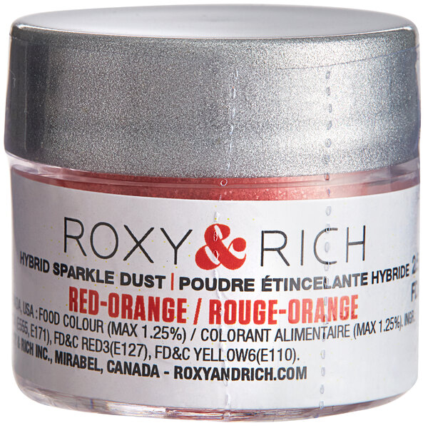 A container of Roxy & Rich red-orange sparkle dust powder.