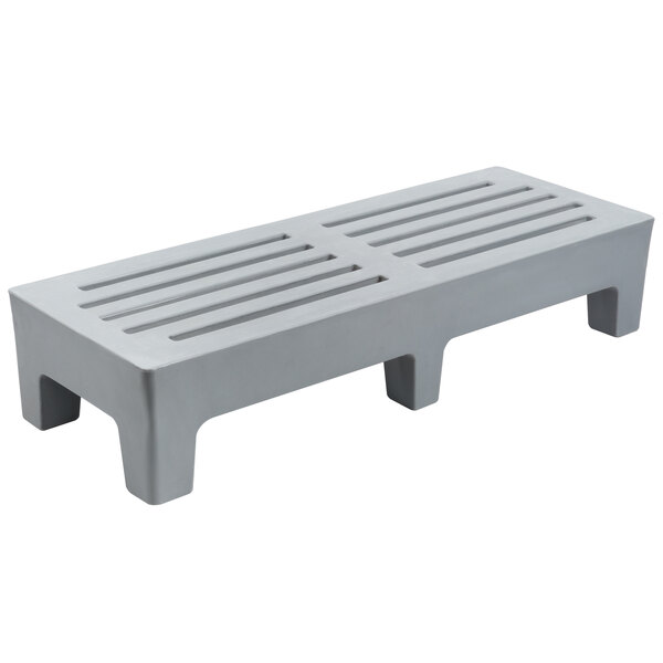 a grey plastic bench with holes