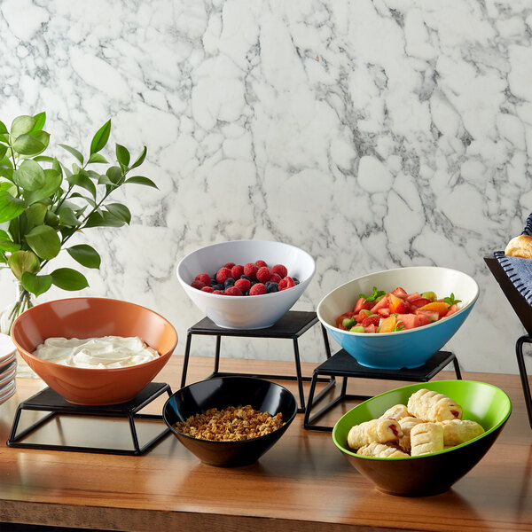 A white San Michele melamine bowl filled with food on a table.