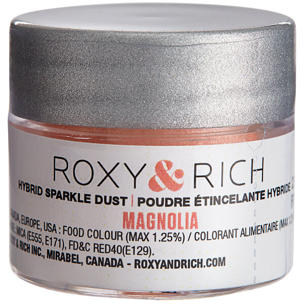 A close-up of a container of Roxy & Rich Magnolia Sparkle Dust powder.