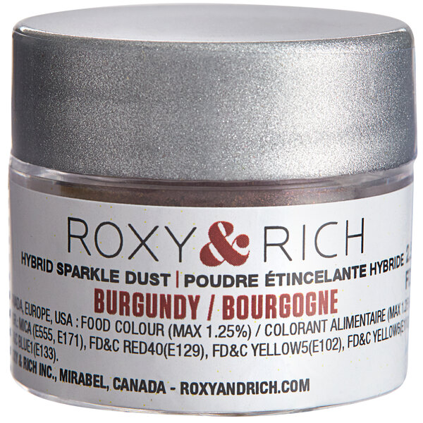 A silver Roxy & Rich container of burgundy powder with a white label.