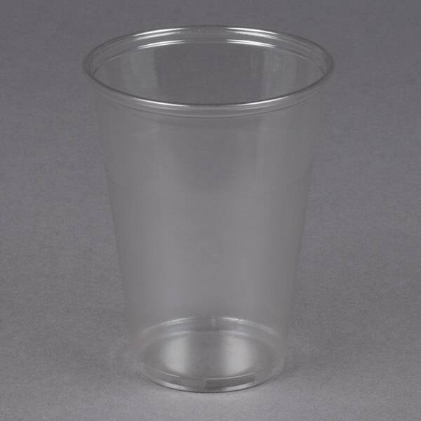 A Solo Ultra Clear plastic cup on a gray surface.
