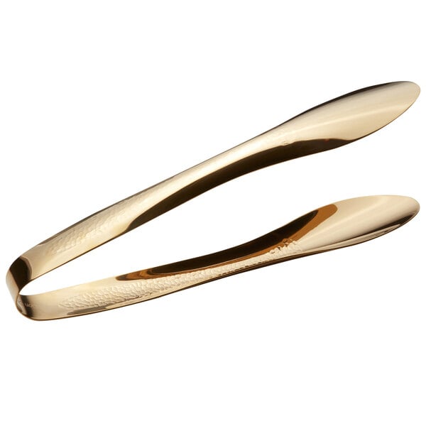 A pair of gold Bon Chef tongs with hammered handles.