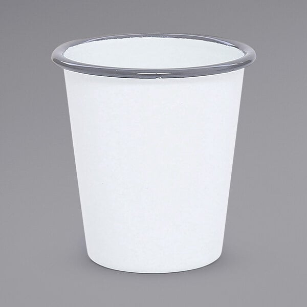 A white enamelware tumbler with a grey rim.
