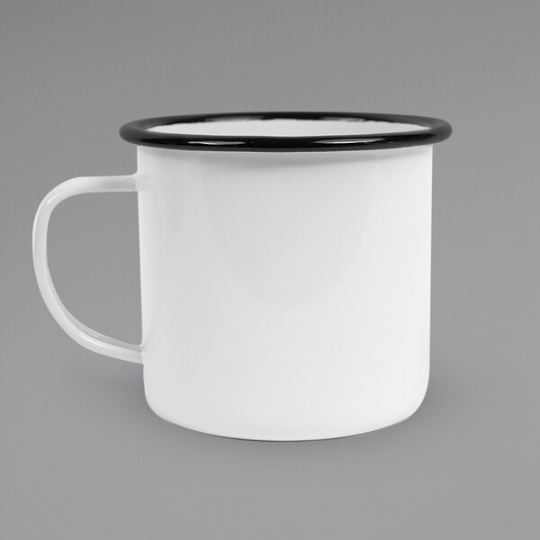 A Crow Canyon Home white enamel mug with a black rim.