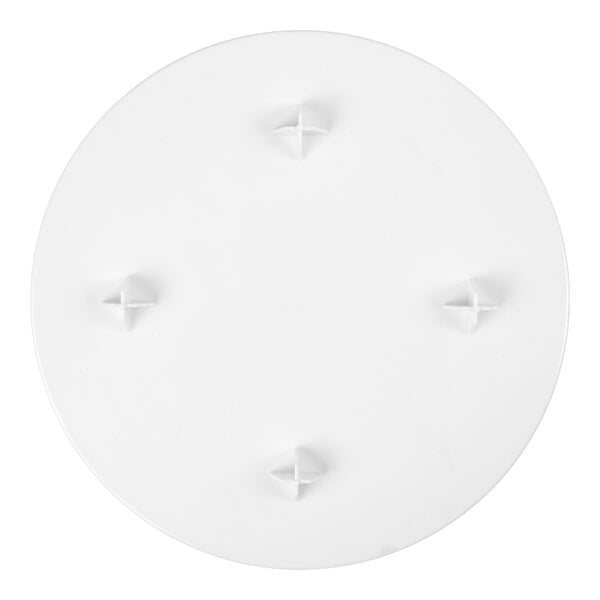 A round white plate with four raised cross-shaped supports evenly spaced near the center.