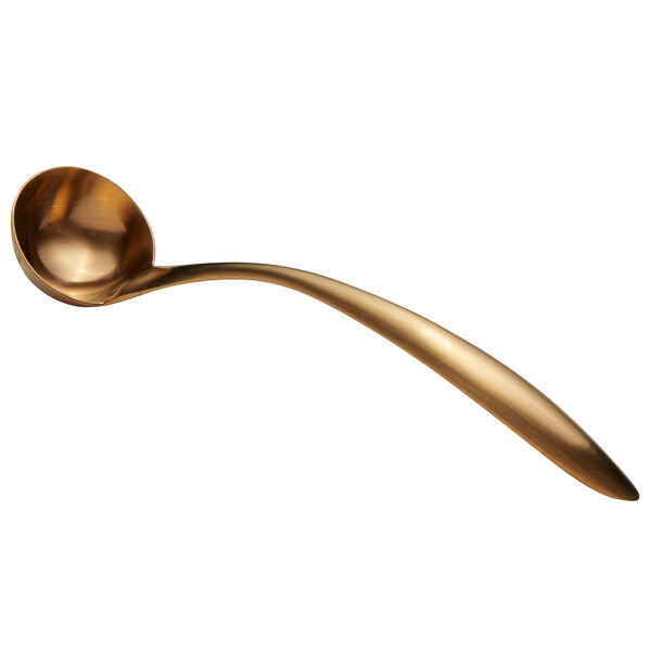 a gold ladle with a long handle