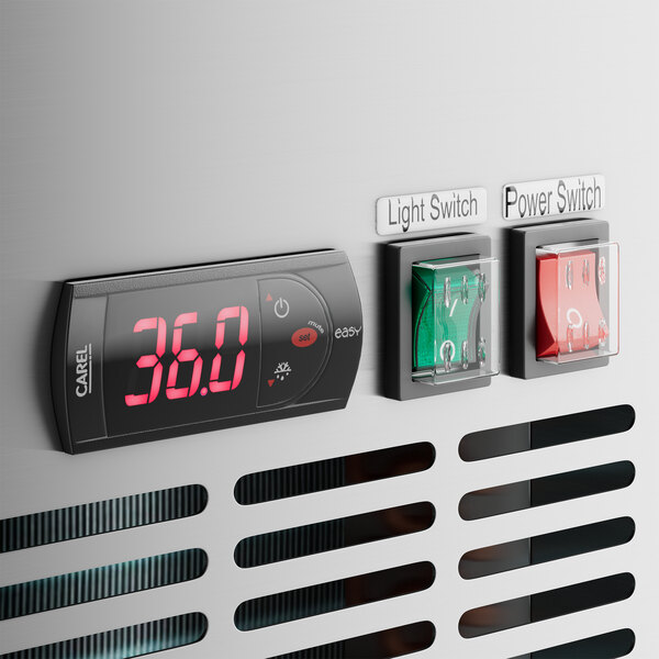 A close-up of a red switch with white numbers on a digital display.