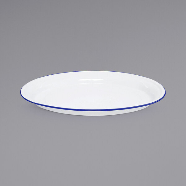 A white Crow Canyon Home enamelware platter with a blue rim.