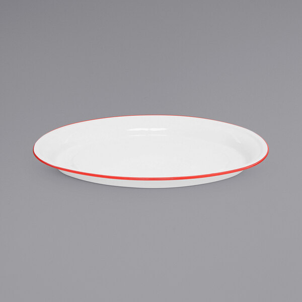 A white Crow Canyon Home enamelware platter with red trim.