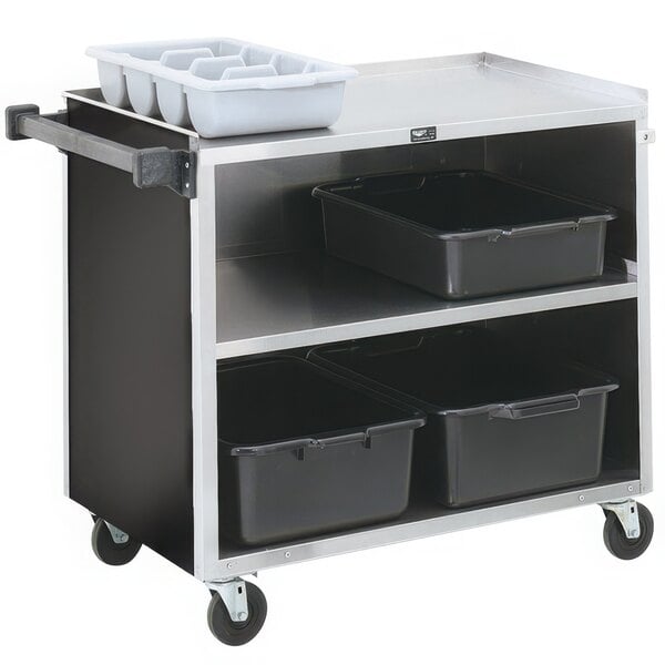 A Vollrath metal bussing cart with three black shelves holding black bins.