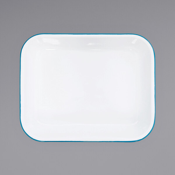 A white enamelware roasting pan with a turquoise rim.