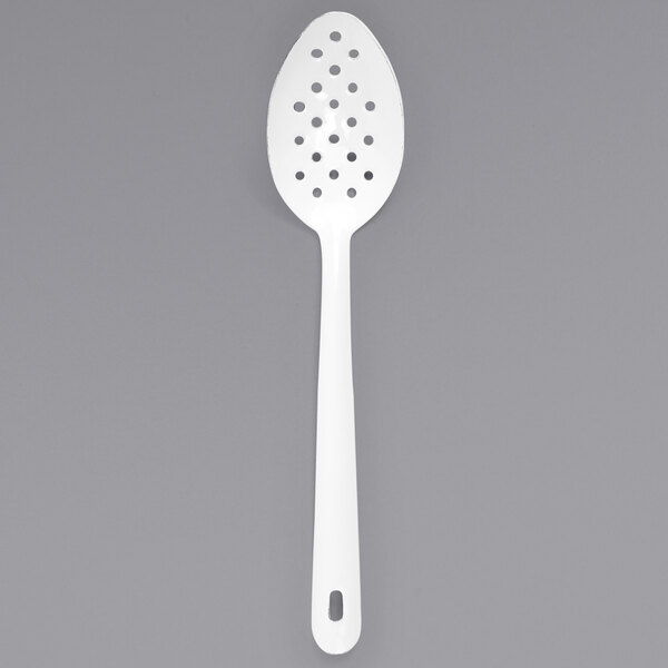 A white Crow Canyon Home enamelware slotted spoon.