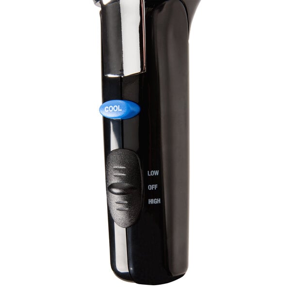 A Conair Chrome Cord Keeper hair dryer in a hotel room.